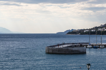Sunrisse over Long stone pier into the sea, Loutraki Greece