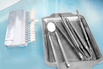 Table with dental instruments in modern clinic, closeup