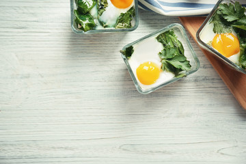 Portions of eggs Florentine on wooden background