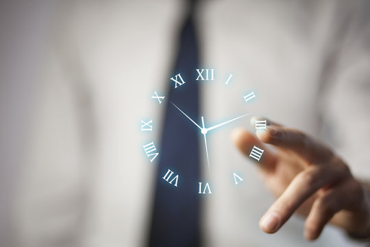 IreriBusinessman hand holding clock