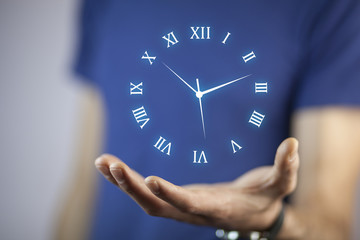 IreriBusinessman hand holding clock