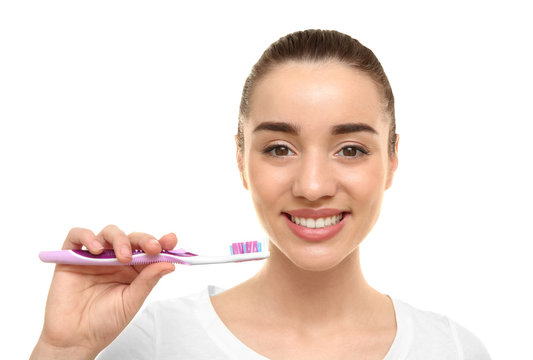 Young beautiful woman brushing teeth on white background. Oral hygiene concept