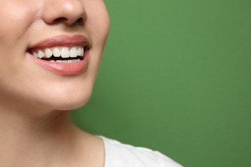 Fototapeta premium Young beautiful woman smiling on color background. Oral hygiene concept