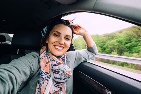 Happy smiling woman sits in auto