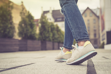 Legs and feet. Young girl walking in the city