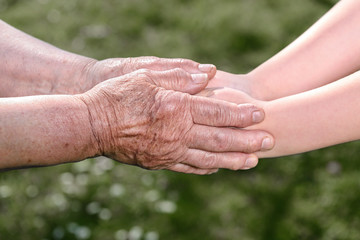 Old and young holding hands