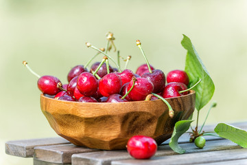 Fresh cherry in a bowl on a wooden table