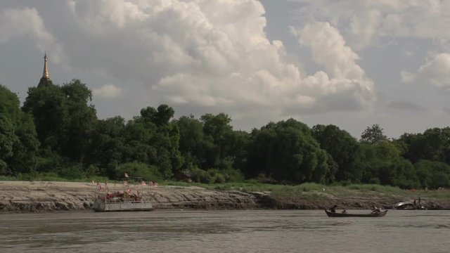 Boating on the Aye Yarwaddy river, view on golden pagoda