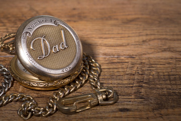  Pocket Watch Inscribed With Dad on a Wooden Surface