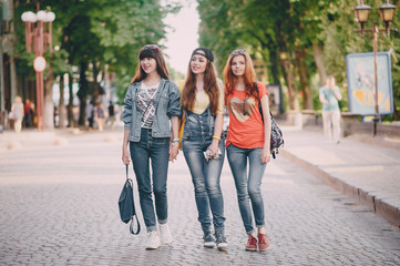 three young girls walking in the park