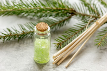Spruce spa with organic salt in bottles on white table background
