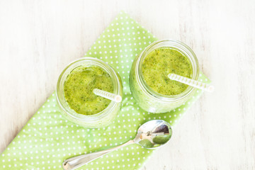 Green Smoothies On Napkin With Straws and Spoon