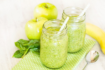 Green Spinach Smoothie With Apples and Banana and Spoon