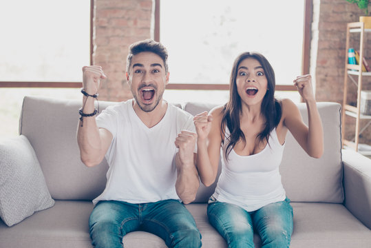 Goal! Yes! Married Young People Are Fans Of Sports Games As  Football, Basketball, Hockey, Baseball, Love Spending Their Weekend At Home Together. They Are Screaming And Gesturing