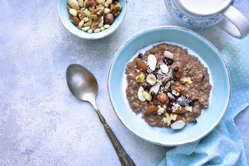 Chocolate oat porridge with nuts.Top view.