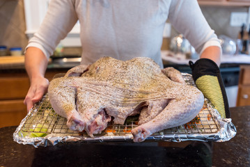 Woman Holding Raw Turkey