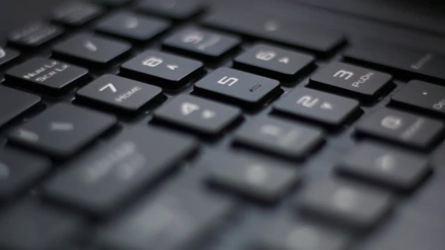 Number pad of back lit laptop keyboard with red pulsing nahimic RGB keys flashing side to side 