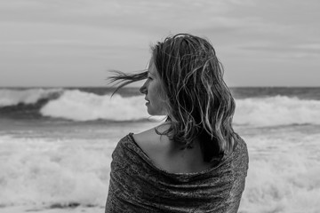 Young woman profile wrapped in scarf on the beach