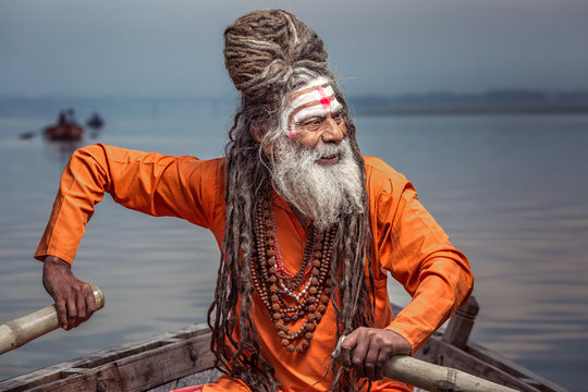 Portrait of sadhu rowing in boat, Varanasi, India