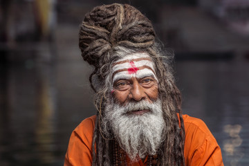 Portrait of sadhu rowing in the boat, Varanasi, India.
