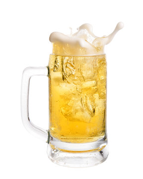 Cold beer splashing out of glass isolated on white background.