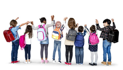 Rear view group of diverse kids standing in a row holdings hands in the air