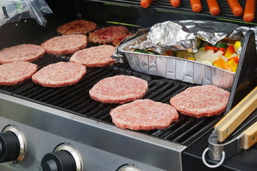 close up on barbecue grill with hotdog and  hamburger steak