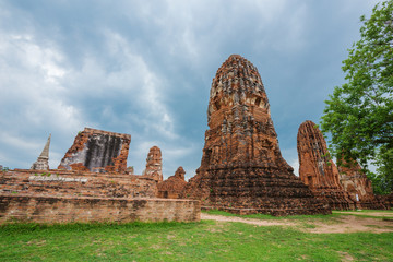 Fototapeta na wymiar Ruins of buddha statues and pagoda of Wat Mahathat in Ayutthaya historical park, Thailand