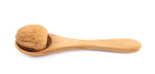 Walnut in a wooden spoon isolated