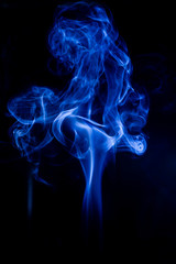 Fototapeta premium Blue toxic fumes movement on a black background.