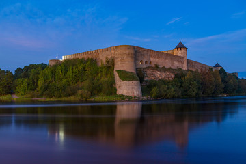 Fototapeta na wymiar Ivangorod medieval fortress on the river Narva at blue hour, Estonia and Russia border.
