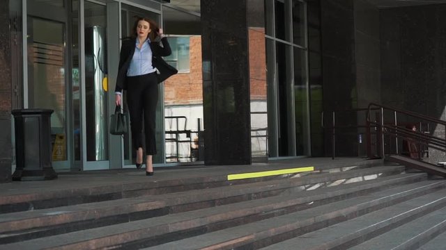 Smart city business woman walking near the huge business centre