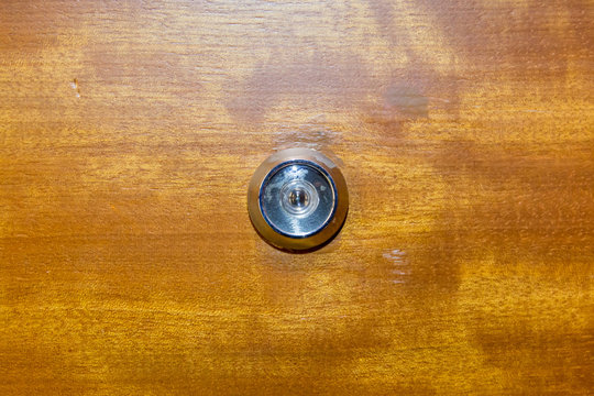 Detail Of Old Lens Peephole On Wooden Door Background, For Security In Hotel.