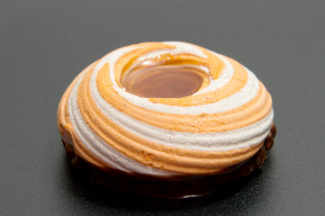 Pile of marshmallows glazed with chocolate. Many coated elegant zephyr dessert isolated on white. Sweet elegant dessert on a plate