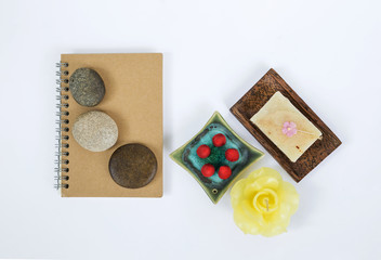 Spa decorate concept on white background, zen stone on notebook with spa decorate