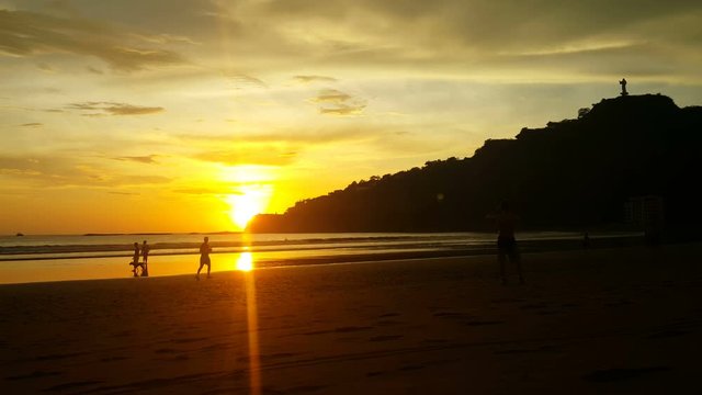 Man takes picture of sunset at the beach of San Juan del Sur