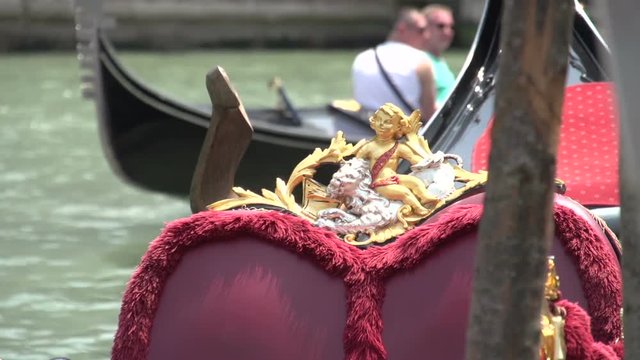 Gondolas waiting for tourists in canal of Venice, close up
