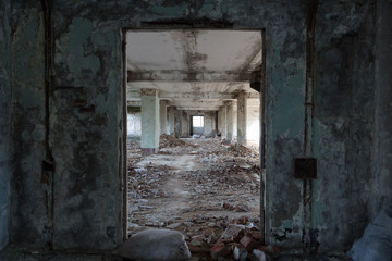 Inside destroyed building, ruins of factory, long corridor, perspective