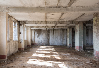 Fototapeta na wymiar Inside abandoned building, ruins, after war concept, sunny light on the floor