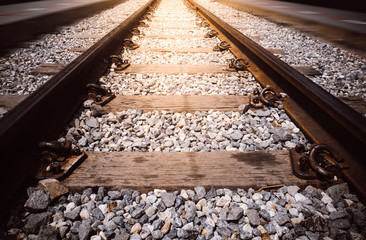 Transportation industry concept background: Railroad in motion with sunset light. Railway station...