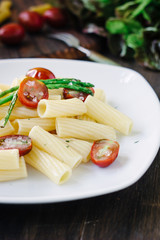 Pasta with asparagus and tomatoes ready to eat
