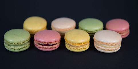 Cake macaron or macaroon isolated on black background, sweet