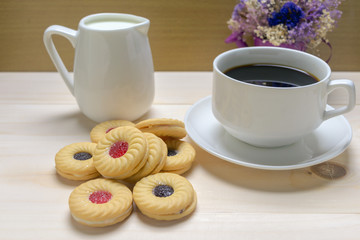 Coffee and biscuits over wooden background