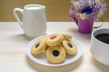 Coffee and biscuits over wooden background
