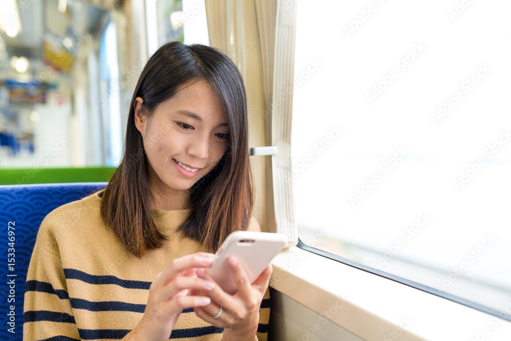 Poster woman use of mobile phone on train