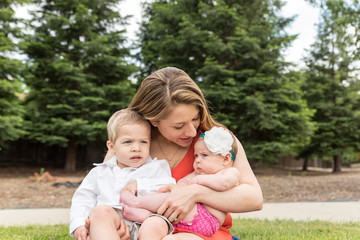 Women Sitting in Park With Kids