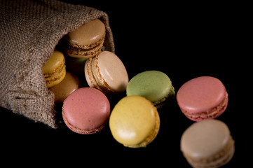Cake macaron or macaroon isolated on black background, sweet