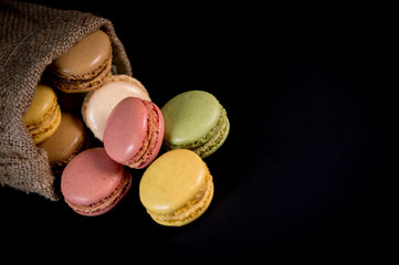 Cake macaron or macaroon isolated on black background, sweet