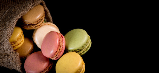 Cake macaron or macaroon isolated on black background, sweet