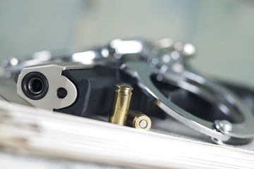 Crime scene with pistol and handcuffs